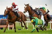 5 April 2015; Jockey Joseph O'Brien falls from his mount Marchese Marconi, right, while second placed Lilshane, with Jonathan Moore up, left, and eventual winner Sir Scorpion, with Tony McCoy up, hidden, race for the line during the Gleesons Butchers Novice Handicap Hurdle. Fairyhouse Easter Festival, Fairyhouse, Co. Meath. Picture credit: Pat Murphy / SPORTSFILE