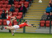 5 April 2015; Enda Lynn, Derry, gets his shot away before Mark Shields, Cork can get his block in. Allianz Football League, Division 1, Round 7, Derry v Cork. Owenbeg, Derry. Picture credit: Oliver McVeigh / SPORTSFILE