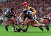 14 September 1997; Liam McGrath, left, and Eugene O'Neill of Tipperary in action against Brian Lohan of Clare during the Guinness All-Ireland Senior Hurling Championship Final between Clare and Tipperary at Croke Park in Dublin. Photo by Ray McManus/Sportsfile