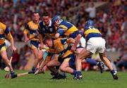 6 July 1997; James O'Connor of Clare in action against John Leahy, Aiden Butler and Conal Bonnar, 18, of Tipperary during the Guinness Munster Senior Hurling Championship Final match between Clare and Tipperary at Páirc Uí Chaoimh in Cork. Photo by Ray McManus/Sportsfile