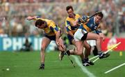 14 September 1997; Ollie Baker of Clare, left, with team-mate P.J O'Connell in action against Liam McGrath of Tipperary during the Guinness All-Ireland Senior Hurling Championship Final between Clare and Tipperary at Croke Park in Dublin. Photo by David Maher/Sportsfile