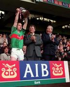 17 March 1998; Birr captain Joe Errity lifts the Tommy Moore Cup, watched by Joe McDonagh, President of the GAA, and Hugh Cawley, AIB Bank, following the All-Ireland Club Hurling Final between Sarsfields and Birr at Croke Park, Dublin. Photo by Brendan Moran/Sportsfile