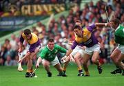 1 September 1996; Adrian Fenlon of Wexford, left, supported by team-mate, Martin Storey, in action against Mike Houlihan, second from left, and Ciaran Carey of Limerick during the GAA All-Ireland Senior Hurling Championship Final match between Wexford and Limerick Croke Park in Dublin. Photo by Ray McManus/Sportsfile