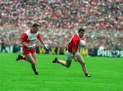 19 September 1993; Cork captain Mick McCarthy races clear from Dermot Heaney of Derry during the All-Ireland Senior Football Championship Final match between Derry and Cork at Croke Park in Dublin. Photo by Ray McManus/Sportsfile