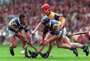 14 September 1997; Liam McGrath, left, and Eugene O'Neill of Tipperary in action against Brian Lohan of Clare during the Guinness All Ireland Hurling Final match between Clare and Tipperary at Croke Park in Dublin. Photo by Ray McManus/Sportsfile