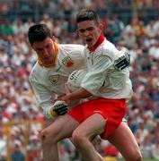 20 July 1997; Mark Harte of Tyrone holds off the challenge of John Finucane of Antrim during the Ulster Minor Football Championship Final at St Tiernach's Park in Clones, Monaghan. Photo by David Maher/Sportsfile