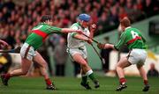 17 March 1998; Peter Cooney of Sarsfields in action against Joe Errity, left, and Simon Whelahan of Birr during the All-Ireland Club Hurling Final between Sarsfields and Birr at Croke Park, Dublin. Photo by Brendan Moran/Sportsfile