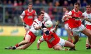 4 June 2000; Colin Holmes of Tyrone in action against Cathal O'Rourke of Armagh during the Bank of Ireland Ulster Senior Football Championship Quarter-Final match between Tyrone and Armagh at St Tiernach's Park in Clones, Monaghan. Photo by Brendan Moran/Sportsfile