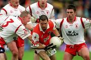 4 June 2000; Steven McDonnell of Armagh is tackled by Chris Lawn, left, and Paul McGurk of Tyrone during the Bank of Ireland Ulster Senior Football Championship Quarter-Final match between Tyrone and Armagh at St Tiernach's Park in Clones, Monaghan. Photo by Brendan Moran/Sportsfile
