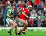4 June 2000; Timmy McCarthy of Cork in action against Mark Foley of Limerick during the Guinness Munster Senior Hurling Championship Semi-Final between Cork and Limerick at Semple Stadium in Thurles, Tipperary. Photo by Ray McManus/Sportsfile