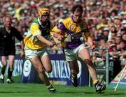 18 June 2000; Adrian Fenlon of Wexford in action against Paudie Mulhare of Offaly during the Guinness Leinster Senior Hurling Championship Semi-Final match between Offaly and Wexford at Croke Park in Dublin. Photo by Aoife Rice/Sportsfile
