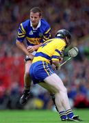 11 June 2000; Brian O'Meara of Tipperary in action against Frank Lohan of Clare during the Guinness Munster Senior Hurling Championship Semi-Final match between Tipperary and Clare at Páirc Ui Chaoimh in Cork. Photo by Ray McManus/Sportsfile