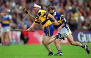 11 June 2000; Colin Lynch of Clare in action against Thomas Dunne of Tipperary during the Guinness Munster Senior Hurling Championship Semi-Final match between Tipperary and Clare at Páirc Ui Chaoimh in Cork. Photo by Ray McManus/Sportsfile