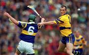 11 June 2000; Ollie Baker of Clare in action against David Kennedy of Tipperary during the Guinness Munster Senior Hurling Championship Semi-Final match between Tipperary and Clare at Páirc Ui Chaoimh in Cork. Photo by Ray McManus/Sportsfile