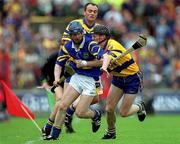 11 June 2000; Paddy O'Brien of Tipperary in action against Frank Lohan, right, and Anthony Daly of Clare during the Guinness Munster Senior Hurling Championship Semi-Final match between Tipperary and Clare at Páirc Ui Chaoimh in Cork. Photo by Ray McManus/Sportsfile