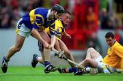 11 June 2000; Philip Maher of Tipperary in action against Alan Markham of Clare as Tipperary goalkeeper Brendan Cummins looks on during the Guinness Munster Senior Hurling Championship Semi-Final match between Tipperary and Clare at Páirc Ui Chaoimh in Cork. Photo by Ray McManus/Sportsfile