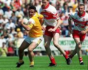 25 June 2000; Aidan Morris of Antrim in action against Enda Muldoon of Derry during the Bank of Ireland Ulster Senior Football Championship Semi-Final match between Antrim and Derry at Casement Park in Belfast, Antrim. Photo by David Maher/Sportsfile