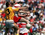 25 June 2000;  Enda Muldoon of Derry in action against Martin Mulholland of Antrim during the Bank of Ireland Ulster Senior Football Championship Semi-Final match between Antrim and Derry at Casement Park in Belfast, Antrim. Photo by David Maher/Sportsfile