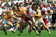 25 June 2000; Patrick Bradley of Derry in action against Enda McLernon, left, and Aidan Morris of Antrim during the Bank of Ireland Ulster Senior Football Championship Semi-Final match between Antrim and Derry at Casement Park in Belfast, Antrim. Photo by David Maher/Sportsfile