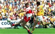 25 June 2000; Ronan Rocks of Derry in action against Georoid Adams of Antrim during the Bank of Ireland Ulster Senior Football Championship Semi-Final match between Antrim and Derry at Casement Park in Belfast, Antrim. Photo by David Maher/Sportsfile