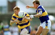25 June 2000; Ronan Slattery of Clare in action against Peter Lambert of Tipperary during the Bank of Ireland Munster Senior Football Championship Semi-Final match between Clare and Tipperary at the Gaelic Grounds in Limerick. Photo by Brendan Moran/Sportsfile
