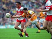 2 July 2000; Patrick Bradley of Derry in action against Peter McCann of Antrim during the Bank of Ireland Ulster Senior Football Championship Semi-Final Replay between Antrim and Derry at Casement Park in Belfast, Antrim. Photo by Aoife Rice/Sportsfile