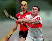 11 June 2000; Ronan McCloskey of Derry in action against John Caughey of Down during the Guinness Ulster Senior Hurling Championship Semi-Final between Derry and Down at Casement Park in Belfast, Antrim. Photo by Aoife Rice/Sportsfile
