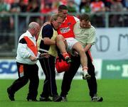 25 June 2000; Diarmaid Marsden of Armagh is carried off after receiving an injury during the Bank of Ireland Ulster Senior Football Championship Semi-Final match between Armagh and Fermanagh at St Tiernach's Park in Clones, Monaghan. Photo by Damien Eagers/Sportsfile