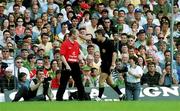 18 June 2000; Cork manager Larry Tompkins is ordered to sit on the bench by referee Mick Curley during the Bank of Ireland Munster Senior Football Championship Semi-Final match between Kerry and Cork at Fitzgerald Stadium in Killarney, Kerry. Photo by Brendan Moran/Sportsfile
