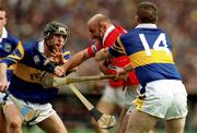 2 July 2000; Brian Corcoran of Cork in action against Eddie Enright, left, and Paul Shelly of Tipperary during the Guinness Munster Senior Hurling Championship Final between Cork and Tipperary at Semple Stadium in Thurles, Tipperary. Photo by Ray McManus/Sportsfile