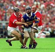 2 July 2000; Paddy O'Brien of Tipperary in action against John Browne, left, and Brian Corcoran of Cork during the Guinness Munster Senior Hurling Championship Final between Cork and Tipperary at Semple Stadium in Thurles, Tipperary. Photo by Brendan Moran/Sportsfile