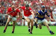 2 July 2000; John Browne, centre, and Brian Corcoran of Cork in action against Paddy O'Brien of Tipperary during the Guinness Munster Senior Hurling Championship Final between Cork and Tipperary at Semple Stadium in Thurles, Tipperary. Photo by Brendan Moran/Sportsfile
