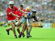 2 July 2000; Michael Ryan of Tipperary is tackled by Timmy McCarthy and Joe Deane of Cork during the Guinness Munster Senior Hurling Championship Final between Cork and Tipperary at Semple Stadium in Thurles, Tipperary. Photo by Brendan Moran/Sportsfile