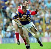 2 July 2000; Paul Shelly of Tipperary is tackled by Cork goalkeeper Donal Og Cusack resulting in Tipperary's first penalty during the Guinness Munster Senior Hurling Championship Final between Cork and Tipperary at Semple Stadium in Thurles, Tipperary. Photo by Brendan Moran/Sportsfile