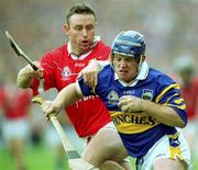 2 July 2000; Eugene O'Neill of Tipperary in action against Fergal Ryan of Cork during the Guinness Munster Senior Hurling Championship Final between Cork and Tipperary at Semple Stadium in Thurles, Tipperary. Photo by Brendan Moran/Sportsfile