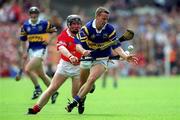 2 July 2000; Brian O'Meara of Tipperary in action against Wayne Sherlock of Cork during the Guinness Munster Senior Hurling Championship Final between Cork and Tipperary at Semple Stadium in Thurles, Tipperary. Photo by Brendan Moran/Sportsfile