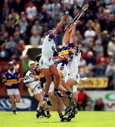 28 May 2000; Peter Queally, left, and James Murray of Waterford in action against Mark O'Leary of Tipperary during the Guinness Munster Senior Hurling Championship Quarter-Final between Tipperary and Waterford at Páirc Uí Chaoimh in Cork. Photo by Brendan Moran/Sportsfile