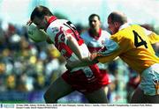 18 June 2000; Johnny McBride, Derry, holds off Anto Finnegan, Antrim. Derry v Antrim, Ulster Football Championship, Casement Park, Belfast. Picture Credit; David Maher/SPORTSFILE