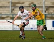 11 April 2015; Mike O'Gorman, Tyrone, in action against Ronan McDermott, Donegal. Allianz Hurling League Division 2B Promotion / Relegation Play-off, Donegal v Tyrone, Owenbeg, Derry. Picture credit: Oliver McVeigh / SPORTSFILE