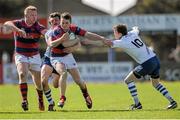 18 April 2015; Max Mac Farlane, Clontarf, is tackled by Ned Hodson, left, and Darragh Lyons, Cork Constitution. Bateman Cup Final, Cork Constitution v Clontarf. Temple Hill, Cork. Picture credit: Eoin Noonan / SPORTSFILE