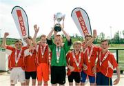 23 April 2015; Cillian Downey, Scoil Iosagain, Buncrana, Co. Donegal, lifts the cup as his team-mates celebrate. SPAR FAI Primary School 5s Ulster Final, Sherlock Park, Cootehill Harps FC, Cootehill, Co. Cavan. Picture credit: Matt Browne / SPORTSFILE