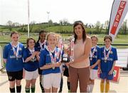 23 April 2015; Margaret Tourish, from Spar Express Burnfoot, Co. Donegal, presents the cup to Eimear Doherty, Illistrim NS, Letterkenny, Co. Donegal. SPAR FAI Primary School 5s Ulster Final. Sherlock Park, Cootehill Harps FC, Cootehill, Co. Cavan. Picture credit: Matt Browne / SPORTSFILE
