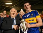 9 April 2015; Tipperary captain Colin O'Riordan is presented with the trophy by Robert Frost, Chairman of the Munster Council. EirGrid Munster U21 Football Championship Final, Tipperary v Cork. Semple Stadium, Thurles, Co. Tipperary. Picture credit: Stephen McCarthy / SPORTSFILE