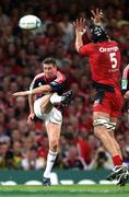 24 May 2008; Munster's Ronan O'Gara gets his kick away despite the attempts of Toulouse's Patricio Albacete. Heineken Cup Final, Munster v Toulouse, Millennium Stadium, Cardiff, Wales. Picture credit: Peter Morrison / SPORTSFILE