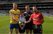 26 April 2015; Match referee Maurice Deegan with Oran Burke, St Joseph's National School, Fairview, and the two captains, Niall Carty, Roscommon, and Conor Laverty, Down, before the game. Allianz Football League, Division 2, Final, Down v Roscommon. Croke Park, Dublin. Picture credit: Ray McManus / SPORTSFILE