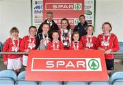 29 April 2015; Laura Cunningham, captain of Kilkerrin NS, Co. Galway, is presented with the cup by Willie O'Byrne, Managing Director of SPAR Ireland, after winning the Girls section A Final. SPAR FAI Primary School 5's Connacht Finals. Milebush Park, Castlebar, Mayo. Picture credit: Diarmuid Greene / SPORTSFILE