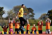 30 April 2015; At the launch of the Forest Feast Little Athletics is Irish International Long Jump Athlete Adam McMullen with the Greystones Little Athletics Club. Charlesland Athletics Track, Greystones, Co. Wicklow. Picture credit: Ramsey Cardy / SPORTSFILE