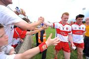 1 June 2008; Fergal Doherty, no.8, Derry, celebrates with his team-mate Eoin Bradley as supporters congratulate both players as they leave the pitch. GAA Football Ulster Senior Championship Quarter-Final, Donegal v Derry, MacCumhaill Park, Ballybofey, Co. Donegal. Picture credit: David Maher / SPORTSFILE