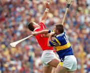 2 July 2000; Diarmuid O'Sullivan of Cork, in action against Paul Shelly of Tipperary during the Guinness Munster Senior Hurling Championship Final between Cork and Tipperary at Semple Stadium in Thurles, Tipperary. Photo by Brendan Moran/Sportsfile