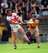 9 July 2000; Kieran McKeever of Derry in action against Malachy Molloy of Antrim during the Guinness Ulster Hurling Championship Final match between Derry and Antrim at Casement Park in Belfast. Photo By Aoife Rice/Sportsfile